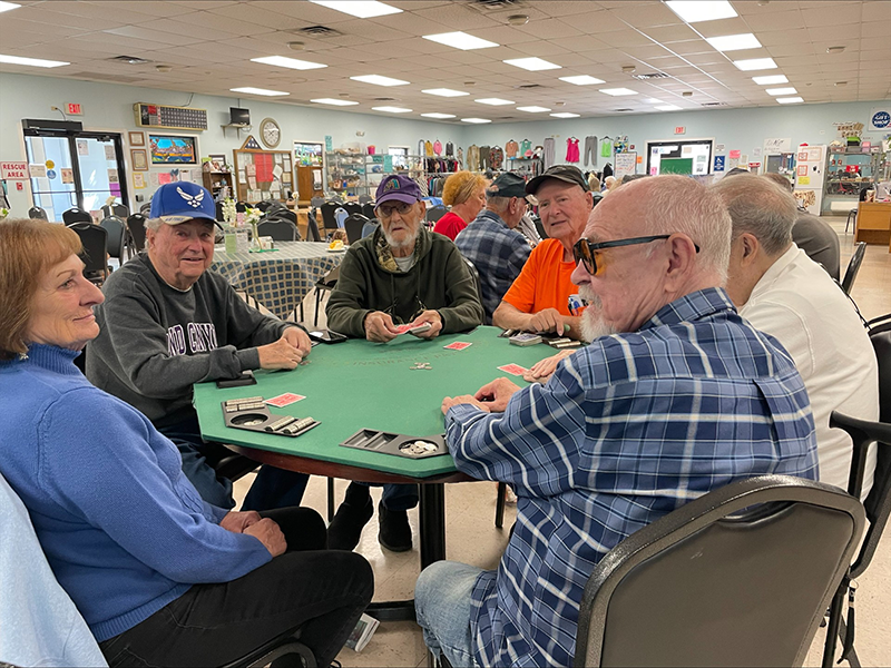 Seniors playing poker at a poker table.